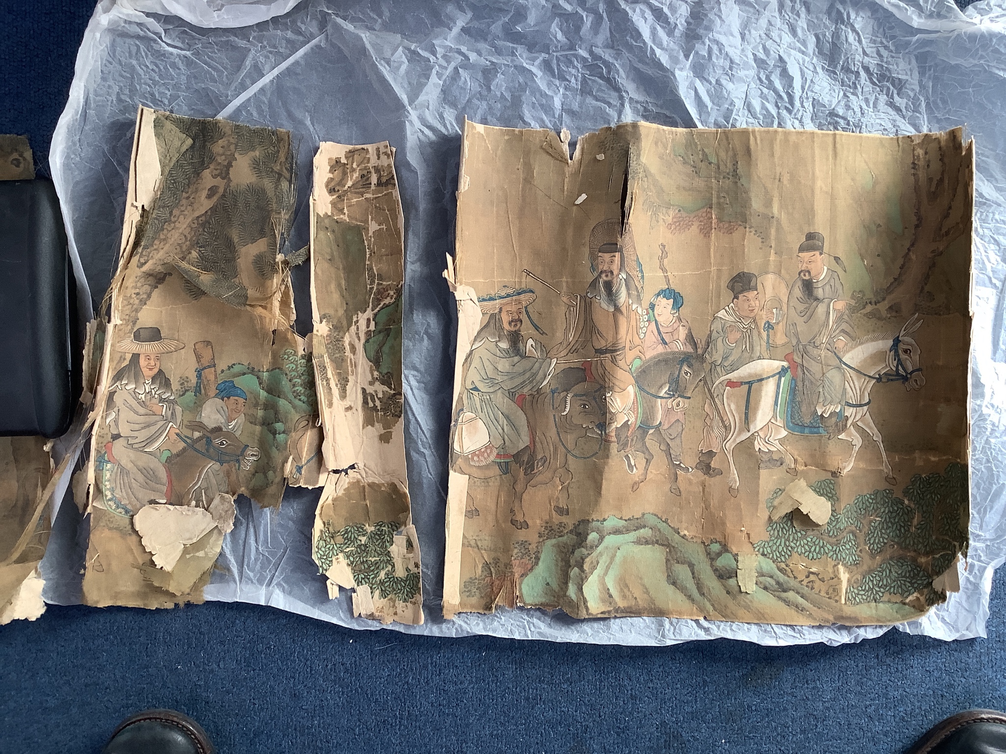 A 19th century Chinese hand scroll painting on silk of figures in a landscape, approximately 206 cm X 32.5 cm